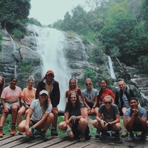 Group photo in front of waterfall